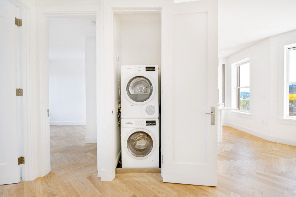 a white laundry room with a washer and dryer in it